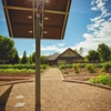 Solar tracker at the Furman Farm with the Shi Institute for Sustainable Communities in the background.