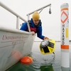 Prof. Craig Hill deploying a wave energy sensor in Lake Superior