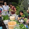 Students working with campus-grown food at the Yale Farm